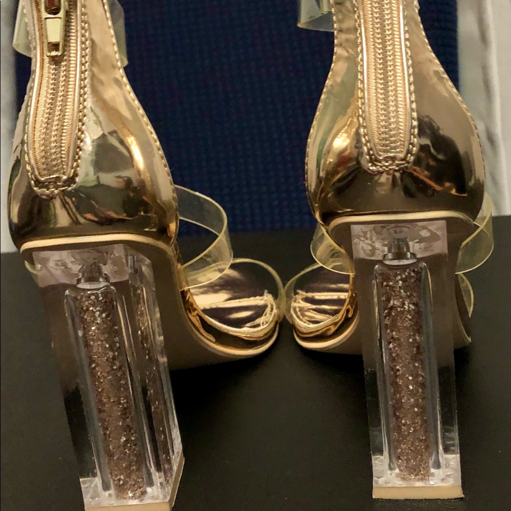 Gold-tone dressy sandals with clear glitter heel.